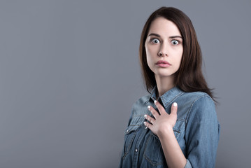 Naklejka premium Surprised and confused young woman