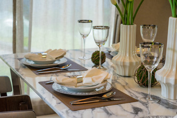 Restaurant table with empty glasses and plates