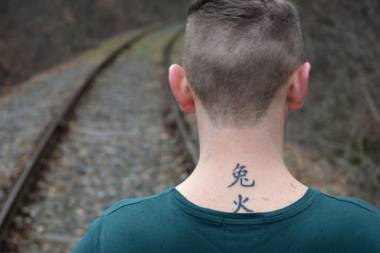 Man With Chinese Letters Tattoo