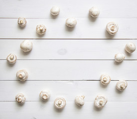 Mushrooms on white wooden table. Top view
