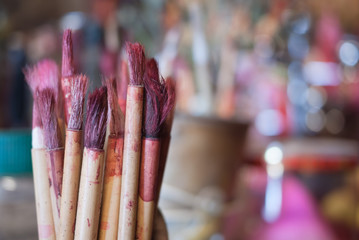 bamboo brush with red ink for chinese calligraph at shrine, selective focus with bokeh