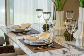 Restaurant table with empty glasses and plates
