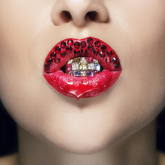 Close up picture of macro red beautiful lips with red beads