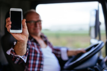 Showing his mobile phone