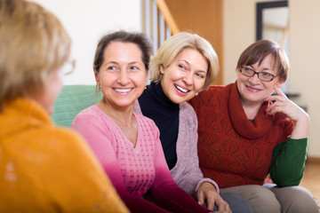 Smiling female pensioners on sofa