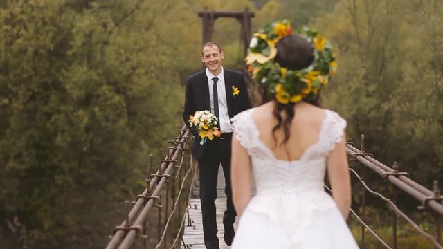 Wedding Bride and Groom Walk on Wooden Bridge. Slow motion