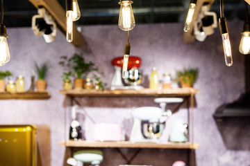 Incandescent light bulbs in a loft style room interior with furniture