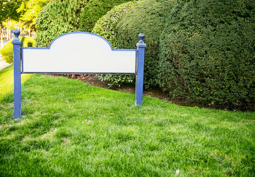 Framed Entrance Sign With Empty Space For Text. Welcome Blank Sign In Grass. The Concept Of Houses And Property For Sale. Mock Up