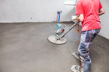 Employee performs sand and cement screed floor. Sand and cement floor screed