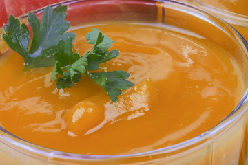 appetizing ripe pumpkin soup in a glass close