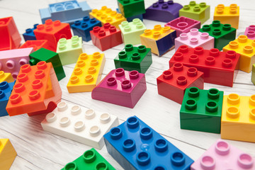 colorful plastic buiding blocks and tiles for kids play on wooden desk