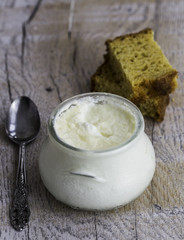 Bowl of yogurt and homemade bread on the wooden background