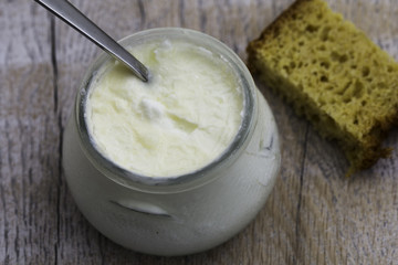 Bowl of yogurt and homemade bread on the wooden background