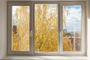 New white window overlook autumn yellow trees