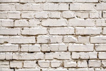 Weathered stained white brick wall, texture grunge background