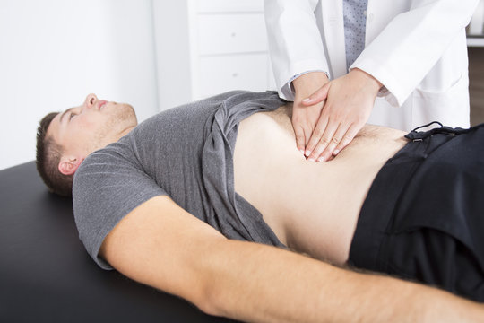 Doctor examining her patient in medical office
