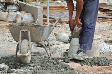 Construction workers doing slump test using equipment at the construction site.  