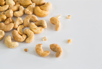 Cashew nuts coated with sugar and salt on white background / Selective focus.