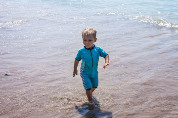 Little boy runs to the sea