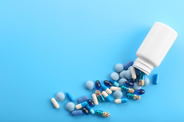 Heap of pills on blue background