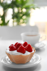 Tasty cakes with strawberries on table