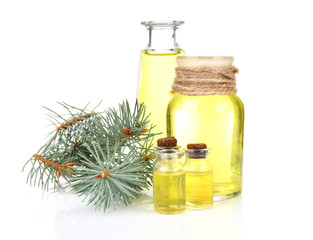 Obraz na płótnie Canvas Bottles of coniferous essential oil and branch isolated on white