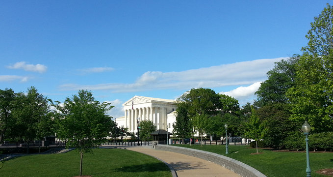 Washington DC, USA - May 07, 2016 - The United States Supreme Court building from a park view.