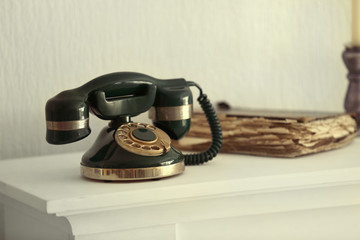 Vintage telephone on white mantelpiece