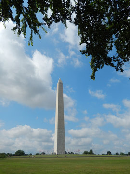 The Washington Monument obelisk landmark against a cloudy sky on the National Mall in Washington DC, USA.

