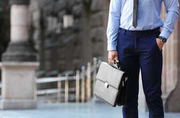 Lawyer holding briefcase on the street