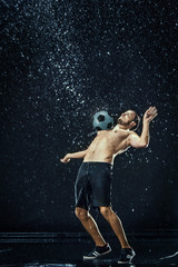 Fototapeta na wymiar Water drops around football player