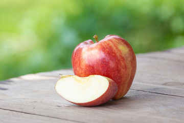 red apple on table outdoors.
