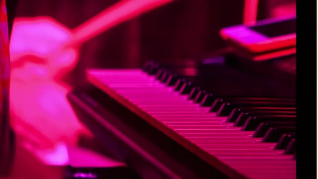 Closeup Girl Plays Piano in Night Bar under Light Flashes