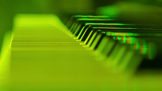 Closeup Electric Piano Keys under Flashes of Colourful Lights