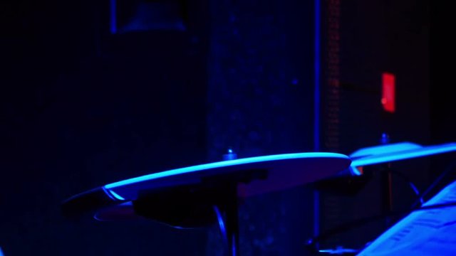Closeup Drummer Plays on Plates in Night Bar under Flashes