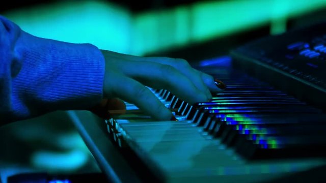 Girl Plays Electric Piano in Night Bar under Light Flashes