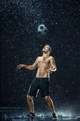 Fototapeta na wymiar Water drops around football player