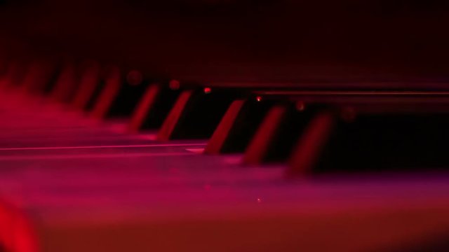 Closeup Electric Piano Keys under Flashes of Colourful Lights
