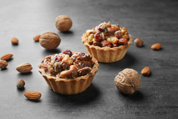 Delicious cakes with nuts on table