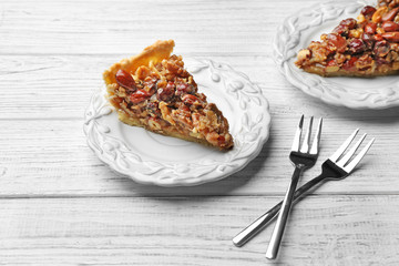 Delicious cake with nuts on table
