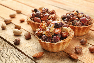 Delicious nut cakes on wooden table