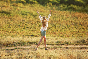 Young woman walking on field background