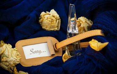 Bottle on a blue background, words on paper