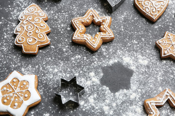 Delicious Christmas cookies with scattered powdered sugar on gray background