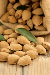 Almonds on brown wooden background