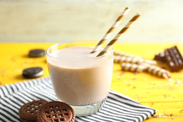 Delicious milkshake with cookies on napkin closeup