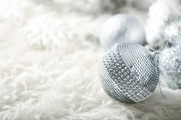 Close up view of beautiful Christmas bauble on white fur