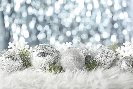 Composition of beautiful Christmas decor on white fur against defocused lights