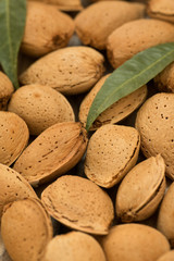 Almonds on brown wooden background