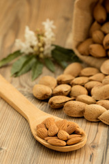 Almonds on brown wooden background